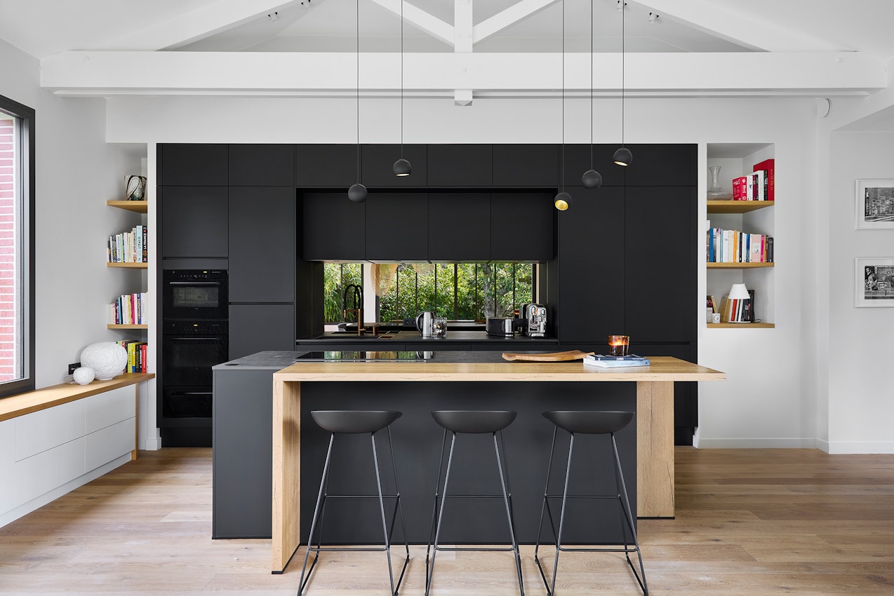 Black kitchen with black dekton and wood tops