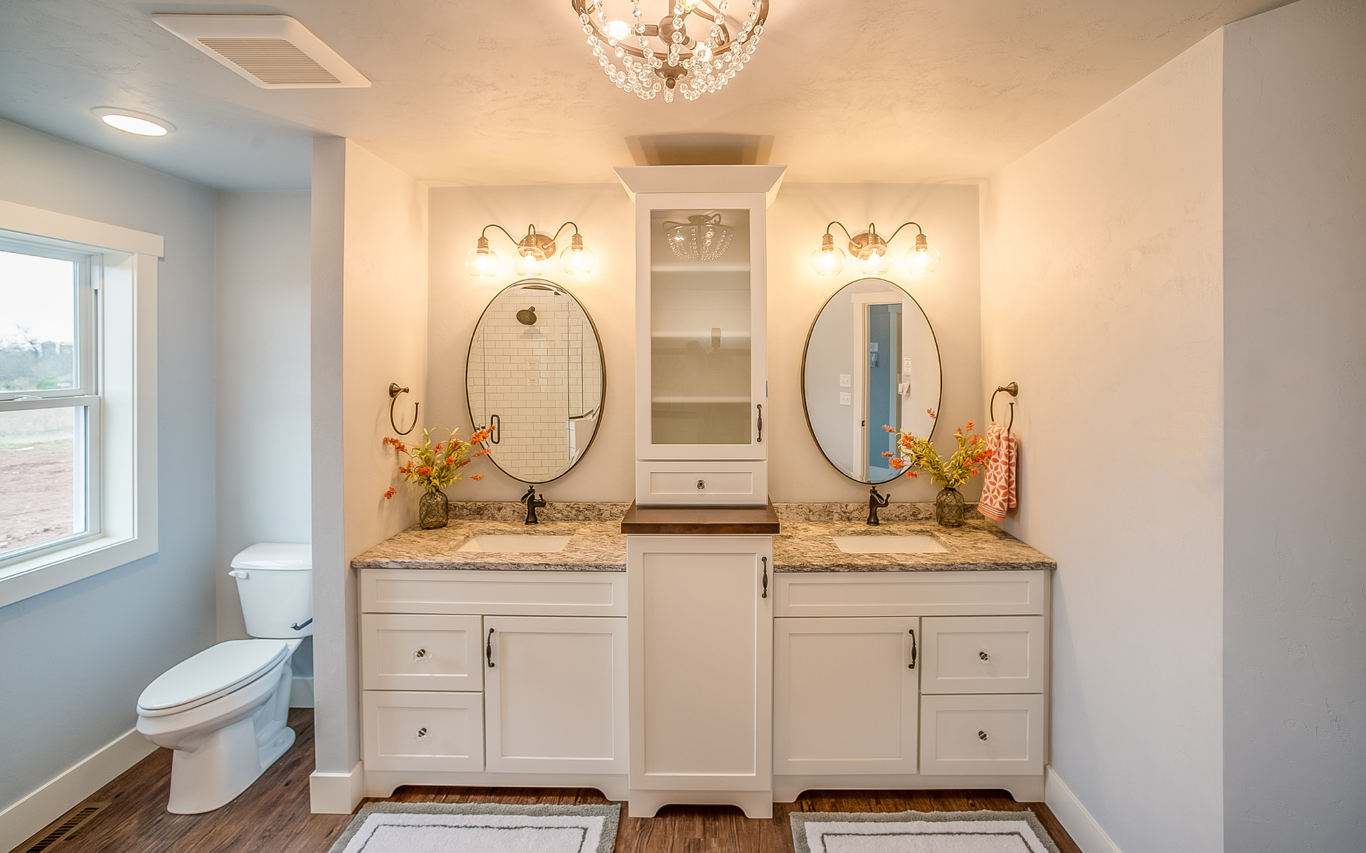 Bathroom with double vanities and toilet